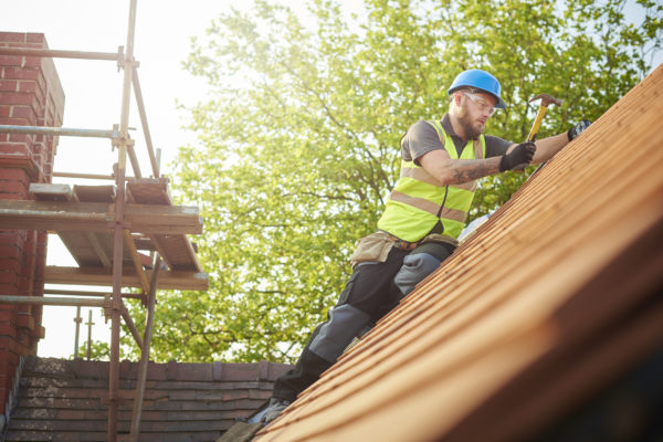 A man working on a roof.