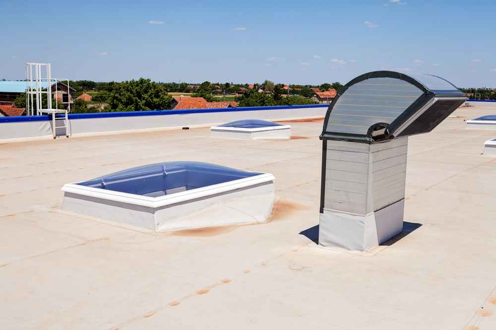 Flat commercial roof in Baton Rouge with roof vents and skylight curbs, the penetrations where low-slope roof leaks most often begin